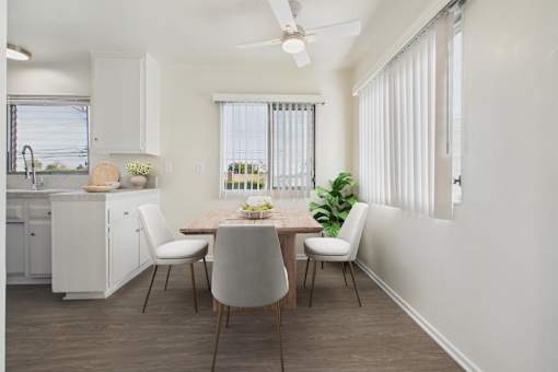 A modern kitchen with a dining table and chairs.