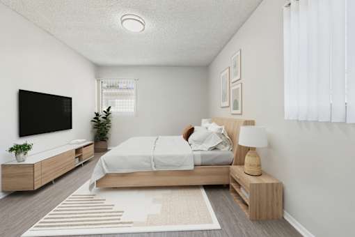 A bedroom with a bed, nightstand, and a television.
