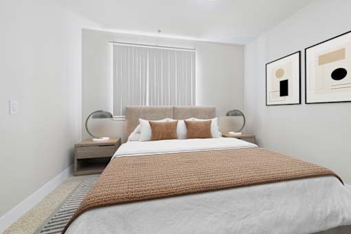 A bedroom with a large bed and two lamps.
