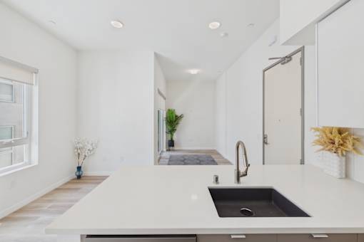 A modern kitchen with a large island and a sink.