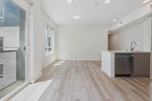 A kitchen with a white counter and a refrigerator.