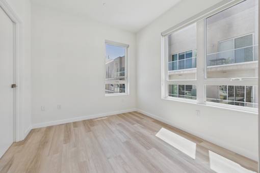 A room with a window overlooking a building.