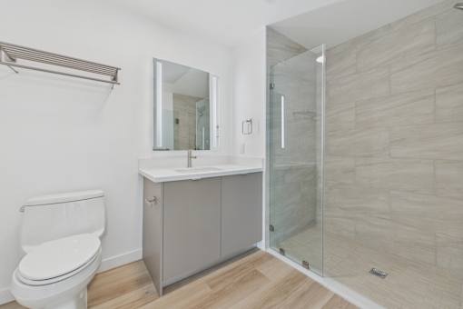 A white toilet sits next to a sink in a bathroom.