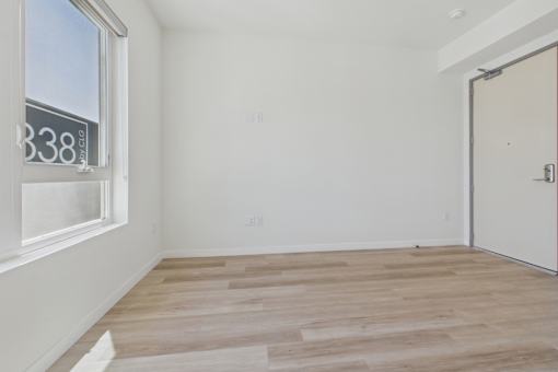 A room with a wooden floor and a door.