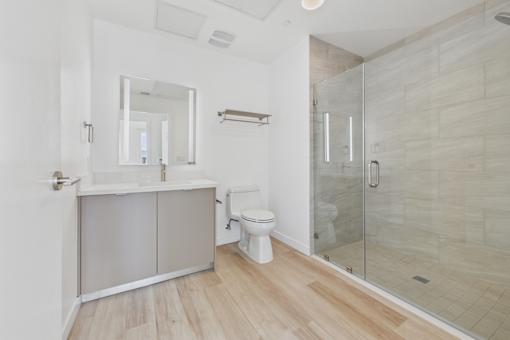 A white bathroom with a walk in shower.