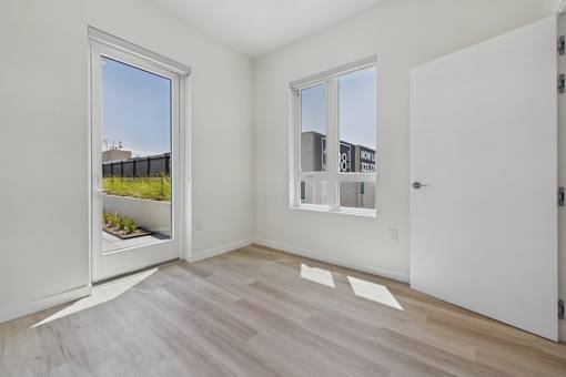 A room with a window and a door.