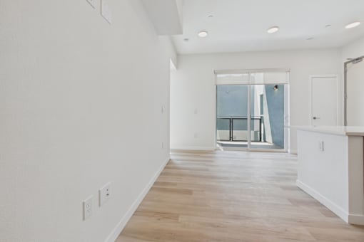 A room with white walls and wooden flooring.