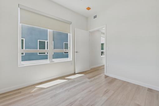 A room with a window and a door.