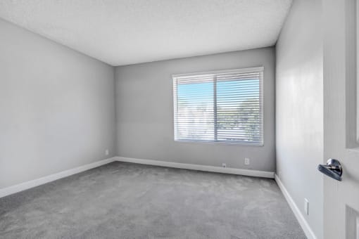 the living room of an empty house with a window