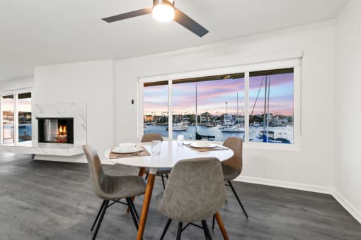 a living room with a table and chairs and a fireplace