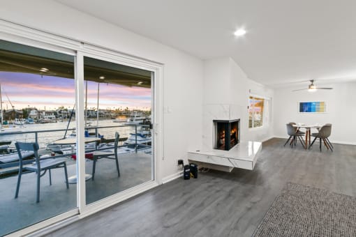 a living room with a fireplace and a table with chairs