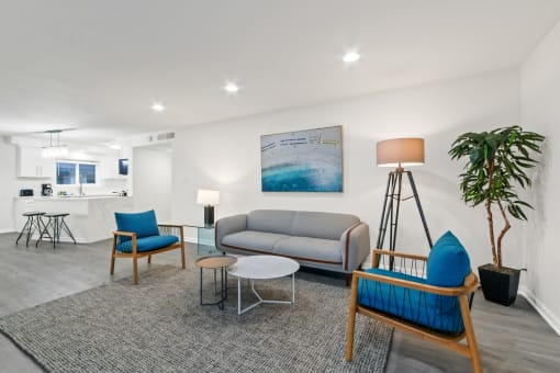 a living room with a couch and chairs and a table