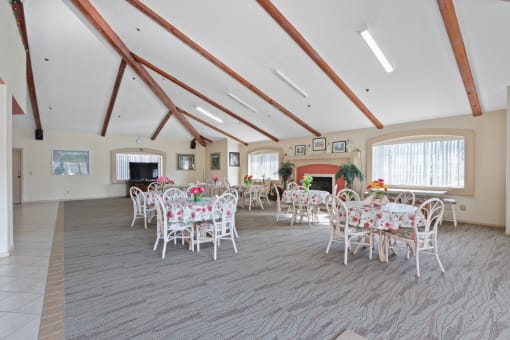 a dining room with tables and chairs and a fireplace