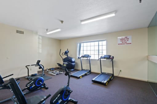 a workout room with exercise equipment at the village