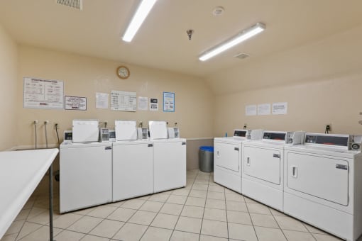 the washer and dryer machines are lined up in the laundry room of an