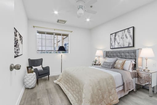 a white bedroom with a bed and a window