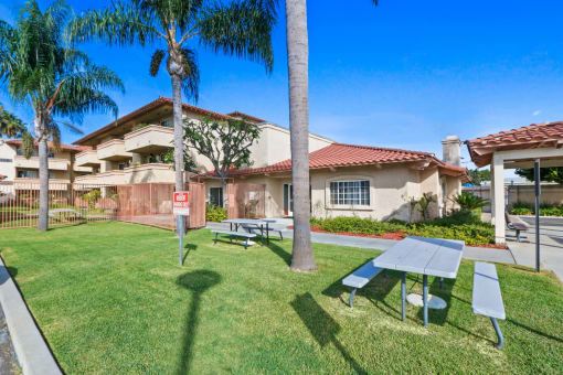 a picnic table in a yard in front of a house