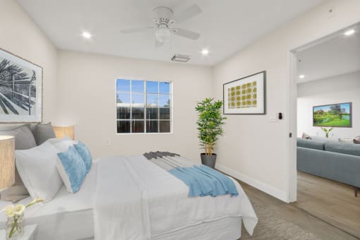 a bedroom with a bed and a ceiling fan