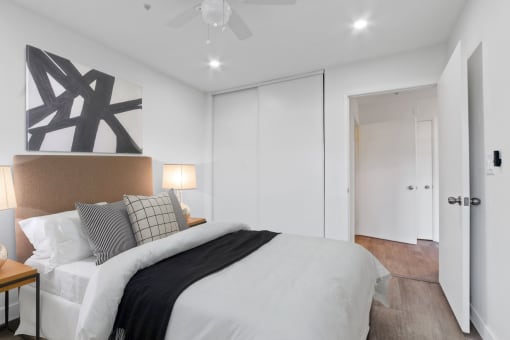 a bedroom with a large bed and a ceiling fan
