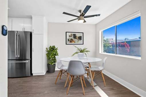 A modern kitchen with a dining table and chairs.