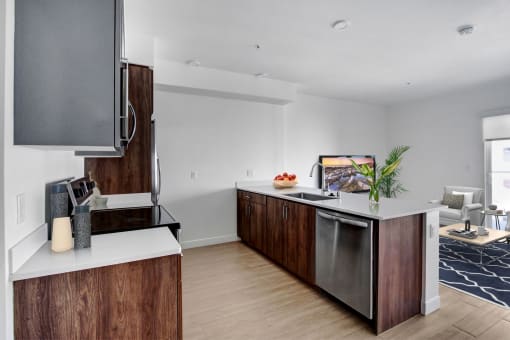 a kitchen with a large island and a stainless steel dishwasher