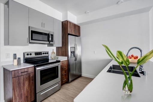 a kitchen with stainless steel appliances and a white counter top