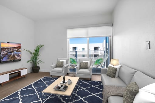 a living room with a couch and a coffee table and a balcony