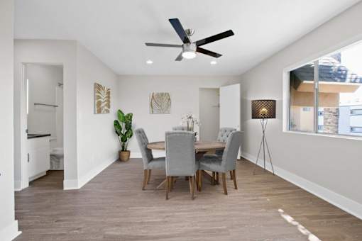 A dining room with a table set for four.