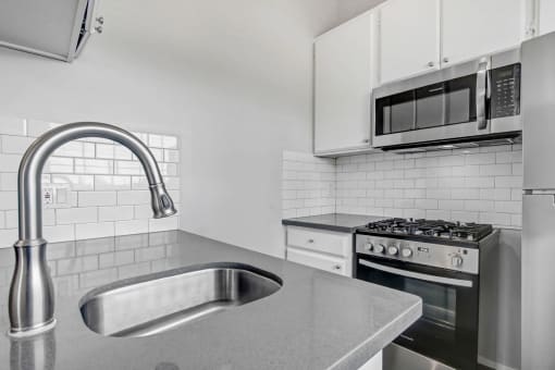 a kitchen with a sink and a microwave