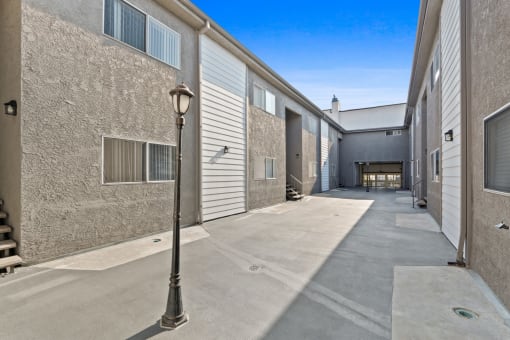 an alleyway between two buildings with a street light