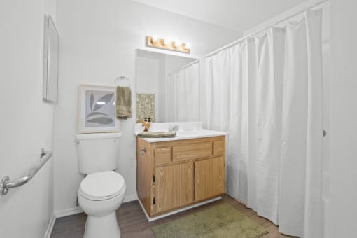 a bathroom with a toilet and a sink and a shower