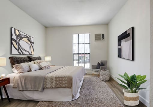a bedroom with a large bed and a large window