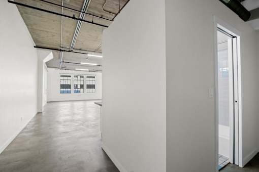 A white room with a door on the right side.