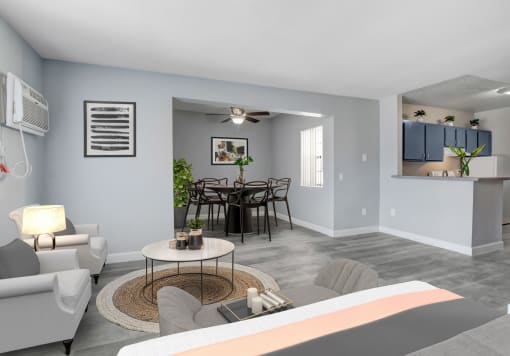 a bedroom with a bed and a table with chairs in a room with a kitchen and a