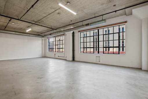 A large empty room with a window on the right side.