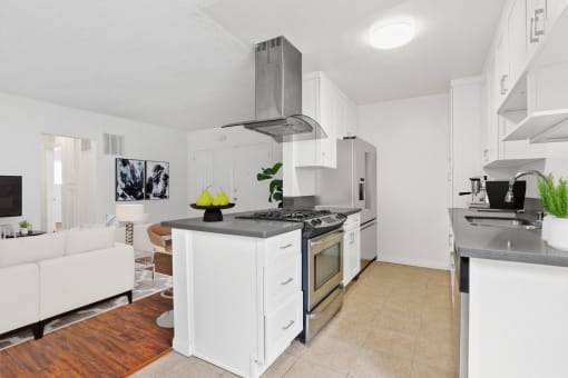 a kitchen with white cabinets and a stove top oven