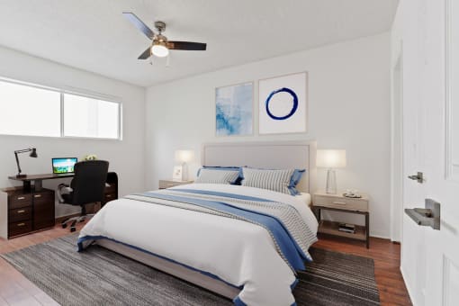 a bedroom with a large bed and a ceiling fan