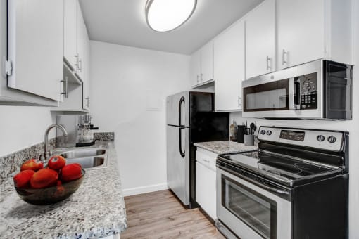 a kitchen with stainless steel appliances and granite counter tops
