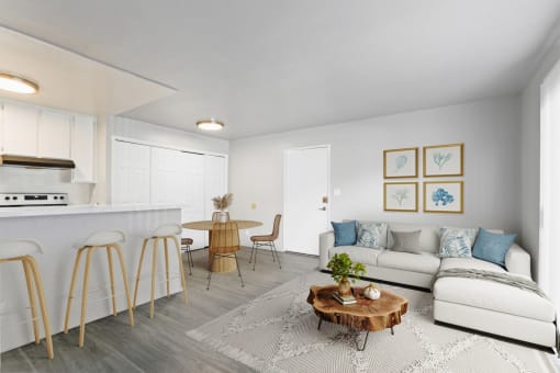 a living room with a couch and a table and a kitchen