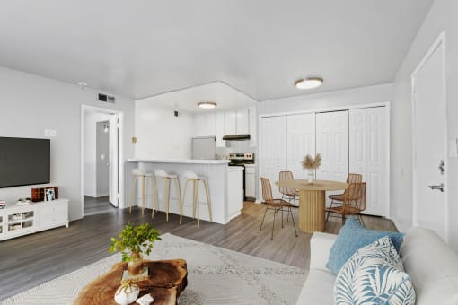 a living room with a couch and a table with chairs