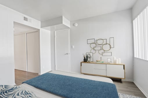 a bedroom with a bed and a blue rug