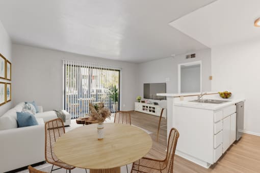 a living room with a kitchen and a dining table