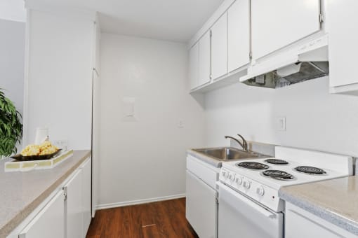 a kitchen with white appliances and white cabinets