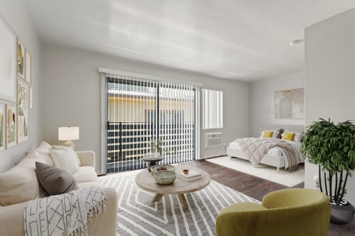 a living room with a couch and a table and a bed