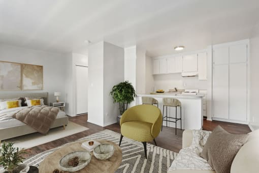a living room with a couch and a chair and a kitchen
