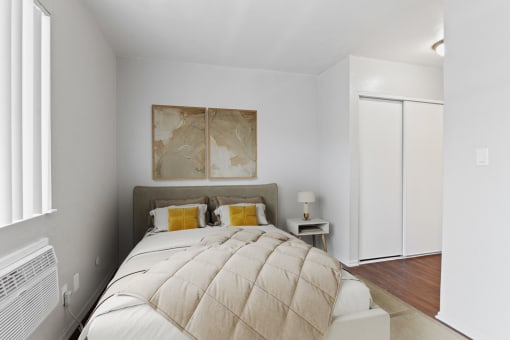 a bedroom with a large bed and a white closet