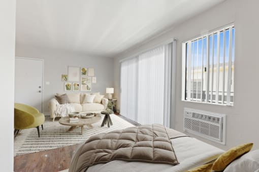 a bedroom with a large bed and a living room with a couch