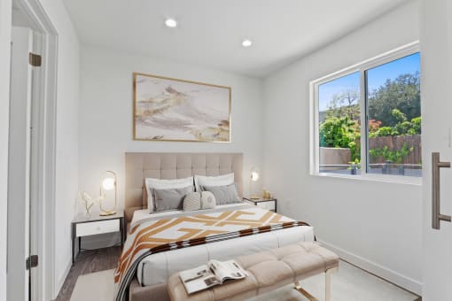 a bedroom with a bed and a large window
