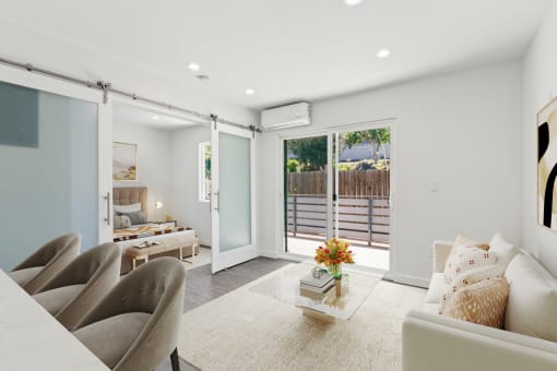 a living room with white walls and sliding glass doors