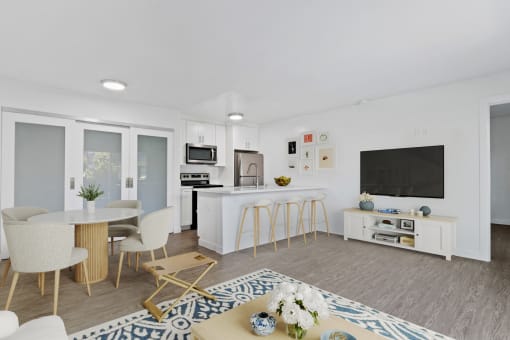 a living room with a kitchen and a table and chairs